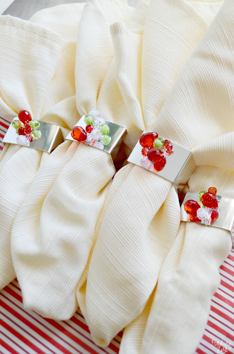 These DIY beaded napkin rings will make your table sparkle this holiday season! All you need is 15 minutes and $2 worth of supplies to make beautiful napkin rings with this fun holiday craft project.  Make extra and give them as a Christmas gift!