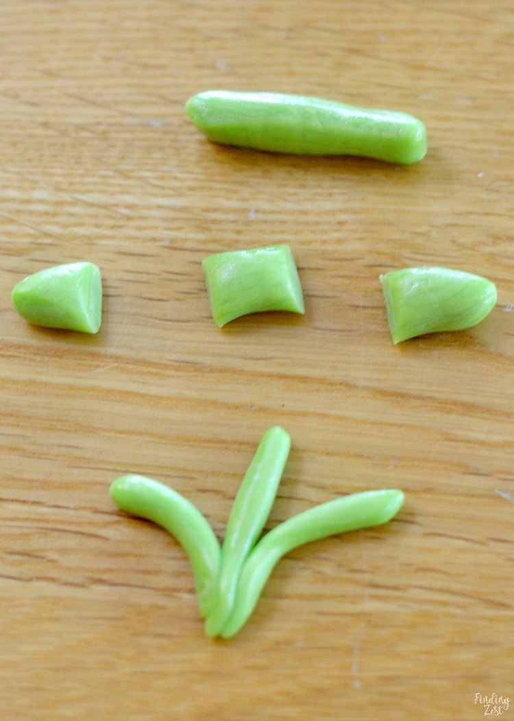 Cut tootsie rolls to make edible grass or reeds