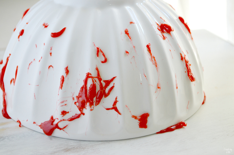 Learn how to make bloody popcorn with bones including directions for adding edible fake blood to your serving dishes! Halloween popcorn has never been so fun and it makes a great snack to serve Halloween party guests!