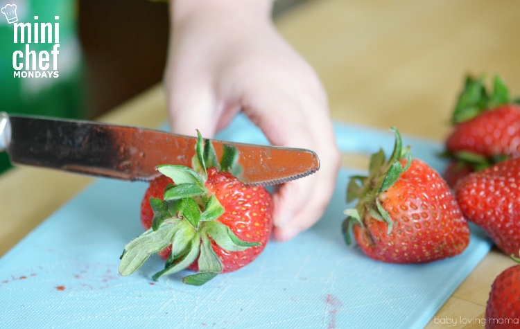 Child Cutting Strawberries for Italian Ice