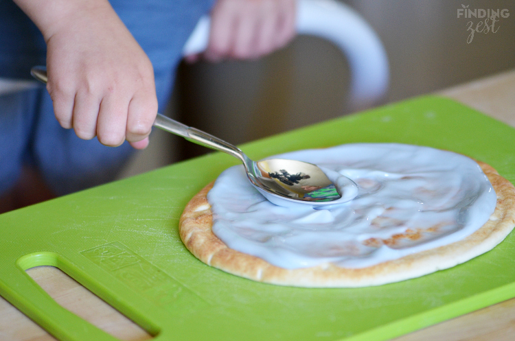 Spreading Yogurt on Breakfast Pizza