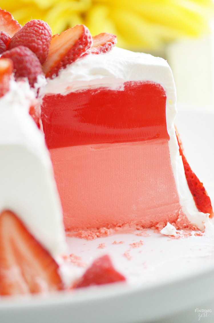 This Strawberry Jello Cake is literally made out of JELL-O! This two layer mock cake is easy and only uses 3 ingredients. No special mold needed! Perfect for those who don't like cake or have food allergies. Make it for your next celebration such as birthdays, Mother's Day, Easter or 4th of July!