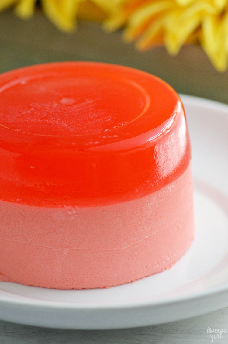 This Strawberry Jello Cake is literally made out of JELL-O! This two layer mock cake is easy and only uses 3 ingredients. No special mold needed! Perfect for those who don't like cake or have food allergies. Make it for your next celebration such as birthdays, Mother's Day, Easter or 4th of July!