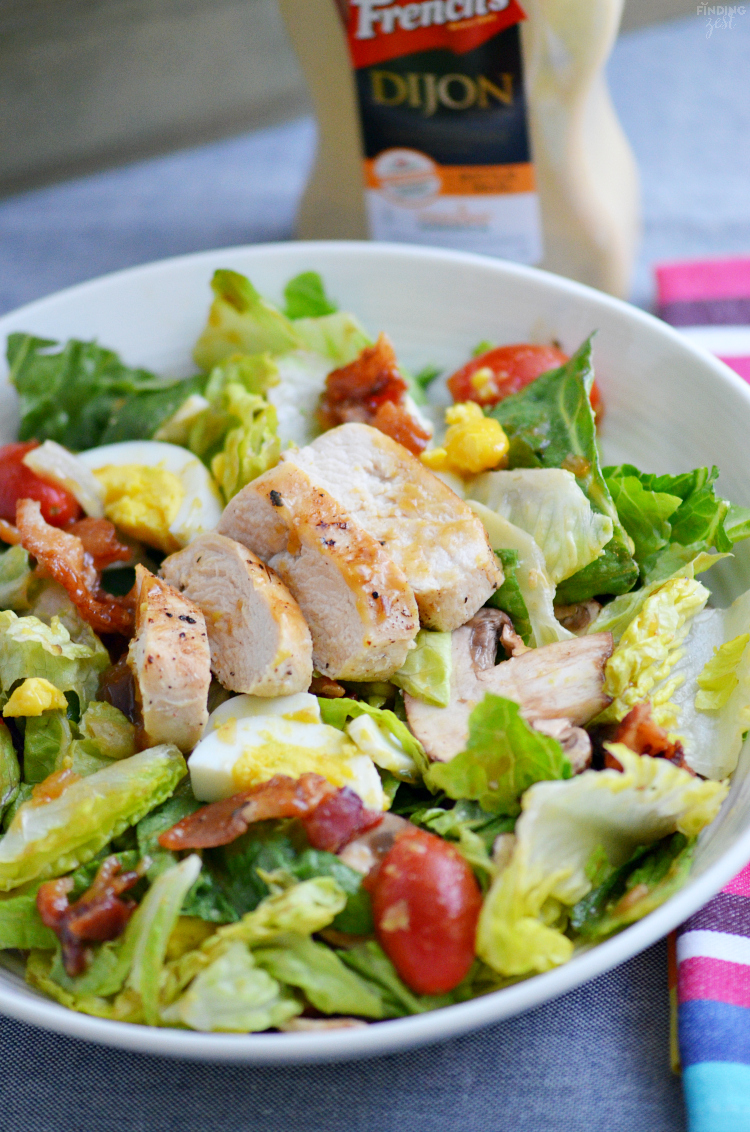 Try something new with this delicious warm chicken bacon salad topped with homemade mustard dressing! Loaded with fresh veggies and plenty of protein, it is a perfect salad for mustard lovers!