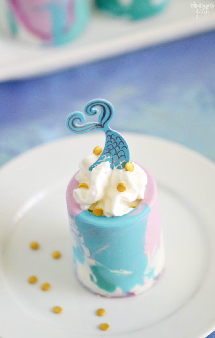 Surprise birthday party guests with these Mermaid Smoothie Shots! These marbled chocolate shot glasses are perfect for filling with your favorite tropical fruit smoothies. These kid friendly shots work great for any Under the Sea themed party!