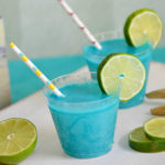 Throwing an mermaid, pool or ocean themed party? This Mermaid Punch recipe is quick and delicious featuring tropical flavors! Your guests will love this blue pina colada punch!