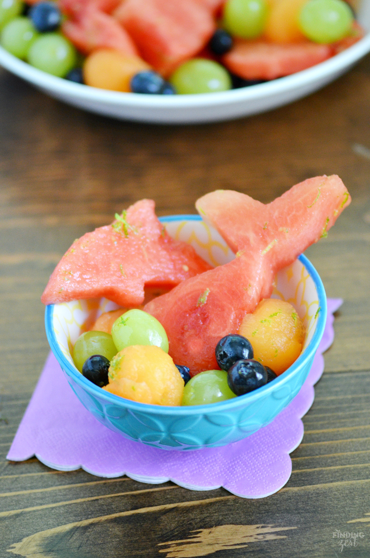 On the hunt for ocean or mermaid party ideas? This Under the Sea Mermaid Honey Lime Fruit Salad is a healthy birthday party food with watermelon cutouts! This kid friendly snack also works well for any brunch, summer cookout or pool party!