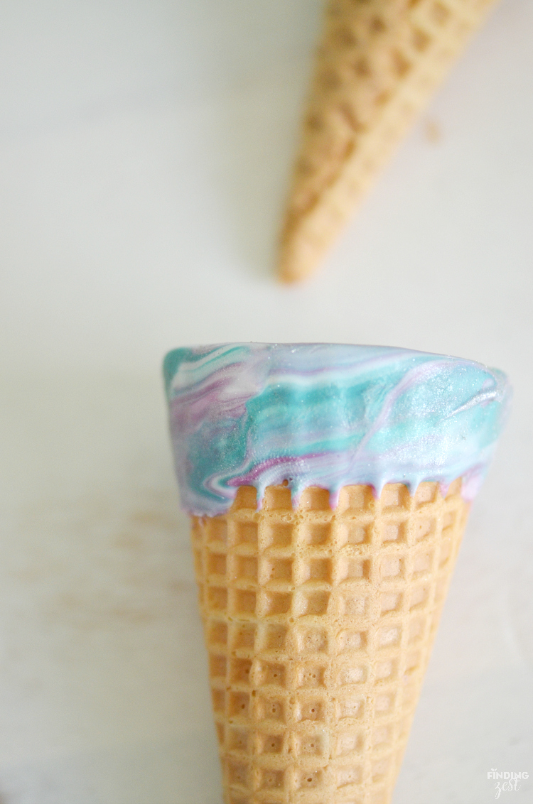 Kick dessert up a notch with these sparkling mermaid ice cream cones! Kids will love these chocolate dipped cones. Perfect for a mermaid or frozen themed birthday party!