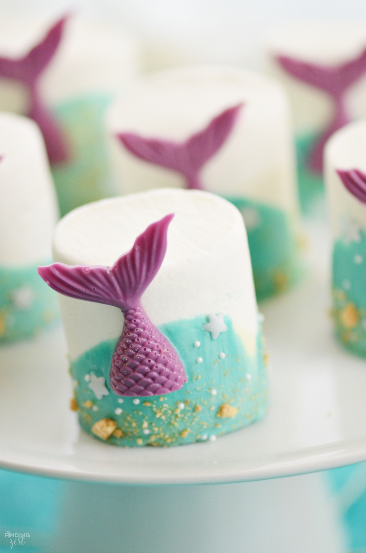 If you are searching for under the sea party ideas, look no further than these mermaid tail marshmallows! This no-bake treat features colorful chocolate mermaid tails and swirled chocolate waves. It is the perfect addition to any mermaid party or under the sea birthday themes!