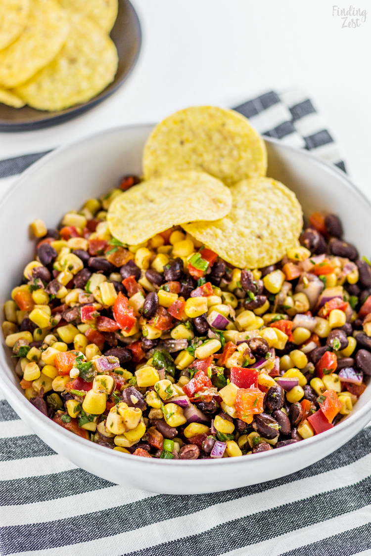 This homemade Black Bean Corn Salsa is sure to be a hit with any crowd! Kick up the flavor to your dinner recipes by serving it as a side dish or as topping to fish, chicken or your favorite Mexican dishes. It also makes for an easy appetizer when served with tortilla chips that everyone will love.