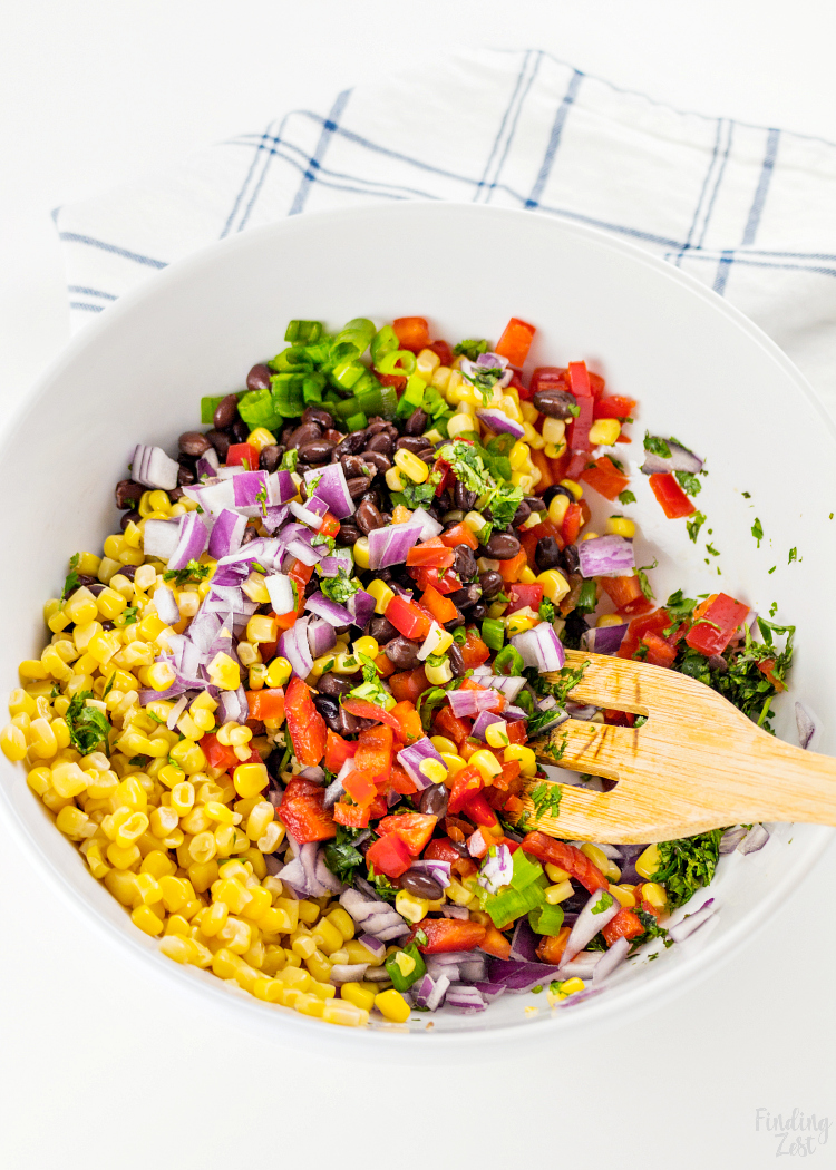This homemade Black Bean Corn Salsa is sure to be a hit with any crowd! Kick up the flavor to your dinner recipes by serving it as a side dish or as topping to fish, chicken or your favorite Mexican dishes. It also makes for an easy appetizer when served with tortilla chips that everyone will love.