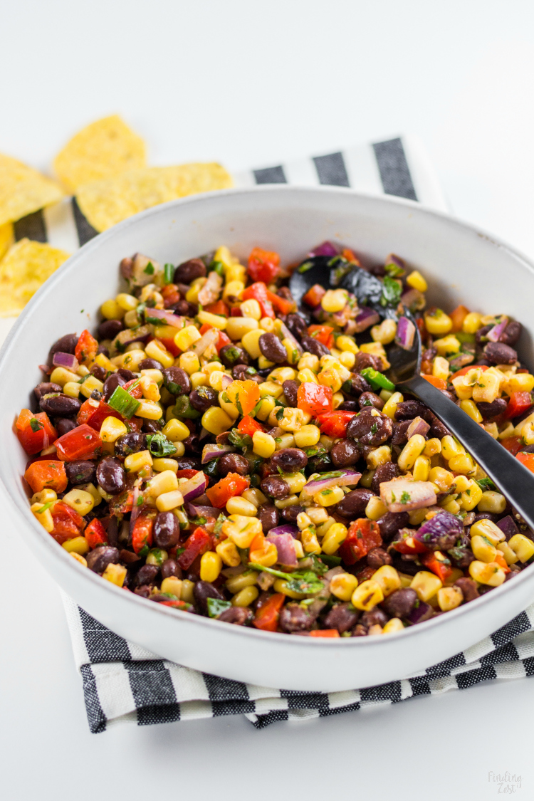 This homemade Black Bean Corn Salsa is sure to be a hit with any crowd! Kick up the flavor to your dinner recipes by serving it as a side dish or as topping to fish, chicken or your favorite Mexican dishes. It also makes for an easy appetizer when served with tortilla chips that everyone will love.