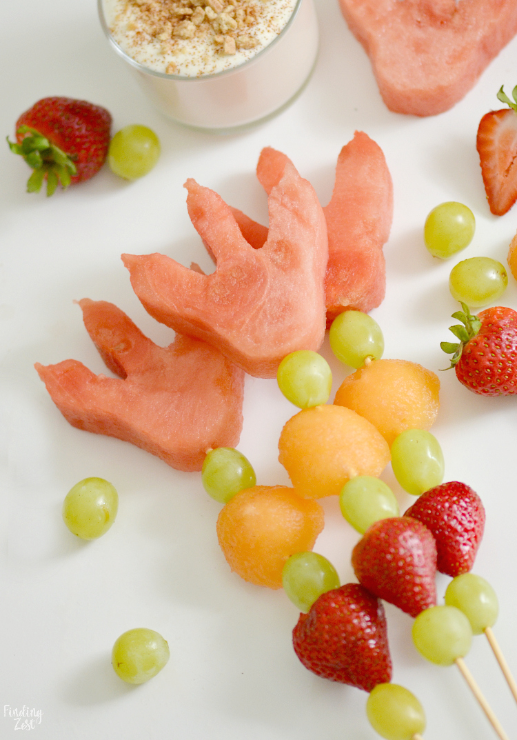 Celebrate the back to school season with this easy dinosaur snack idea with dinosaur footprints! Kids will love these fun dino fruit skewers with yogurt fruit dip inspired by We Don't Eat Our Classmates, a humorous children's book by Ryan T Higgins. 