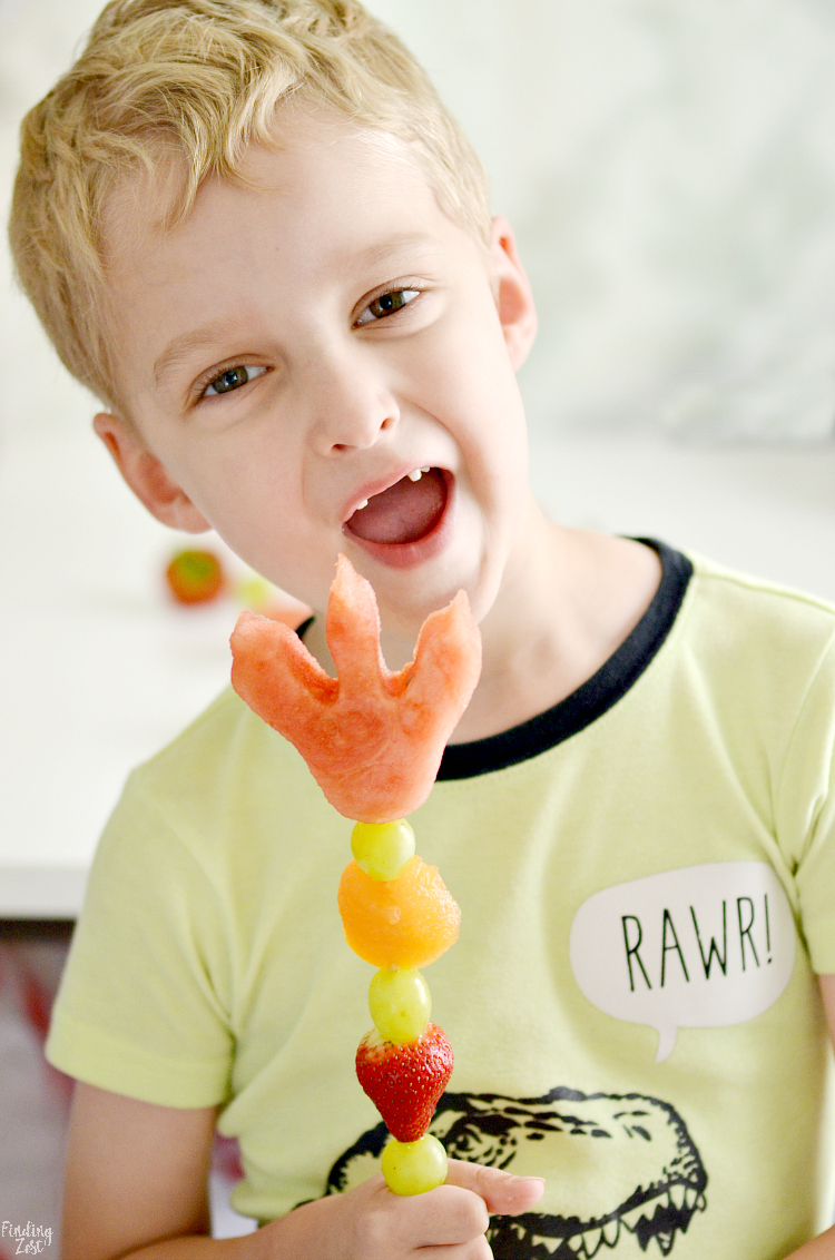 Celebrate the back to school season with this easy dinosaur snack idea with dinosaur footprints! Kids will love these fun dino fruit skewers with yogurt fruit dip inspired by We Don't Eat Our Classmates, a humorous children's book by Ryan T Higgins. 