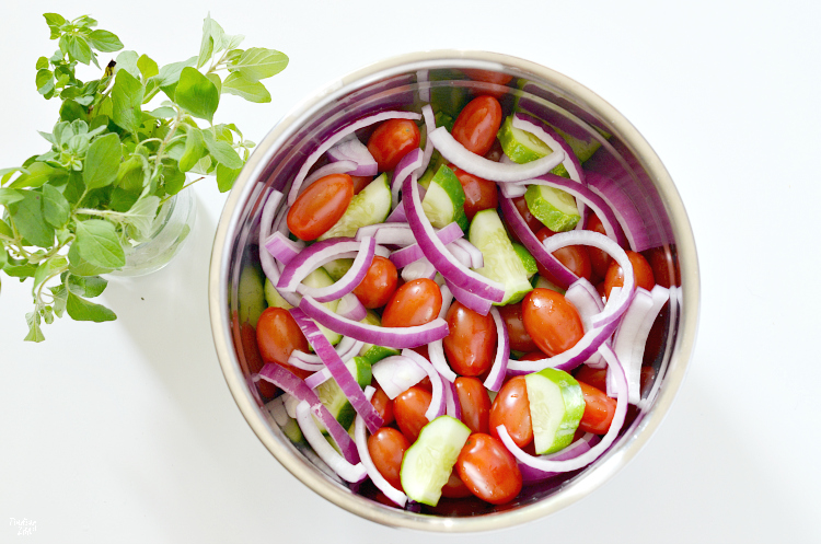 Enjoy this refreshing tomato cucumber salad loaded with fresh herbs, tomatoes, cucumbers, and onion. Let the vegetables marinate in the oil and balsamic vinegar dressing for even more flavor. The perfect side dish for any meal and a great way to use up that fall harvest!