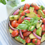 Enjoy this refreshing tomato cucumber salad loaded with fresh herbs, tomatoes, cucumbers, and onion. Let the vegetables marinate in the oil and balsamic vinegar dressing for even more flavor. The perfect side dish for any meal and a great way to use up that fall harvest!