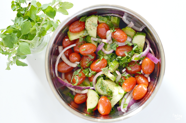 Enjoy this refreshing tomato cucumber salad loaded with fresh herbs, tomatoes, cucumbers, and onion. Let the vegetables marinate in the oil and balsamic vinegar dressing for even more flavor. The perfect side dish for any meal and a great way to use up that fall harvest!