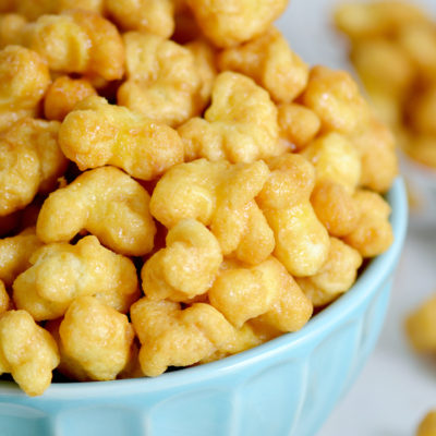 You'll love this caramel puff corn recipe, a tasty alternative to traditional caramel corn. Using bagged puff corn, this easy snack is baked for an awesome crunch. Works great for every day snacking, parties and game day! The hardest part will be keeping your hands off!