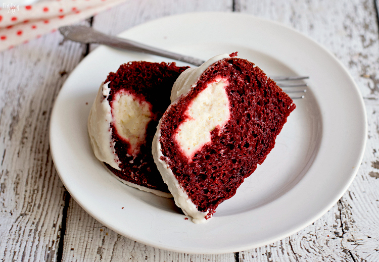 Your family won't be able to resist this red velvet bundt cake with cream cheese filling. Wow guests with this beautiful red and white cake that is easy to make and absolutely delicious. Make it for Christmas dessert or a special Valentine's Day sweet treat!