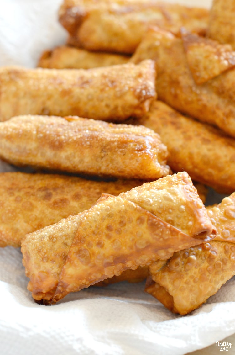 Taco egg rolls are a fun twist on a classic! Try something new with these delicious egg rolls loaded with ground beef, refried beans and cheese!