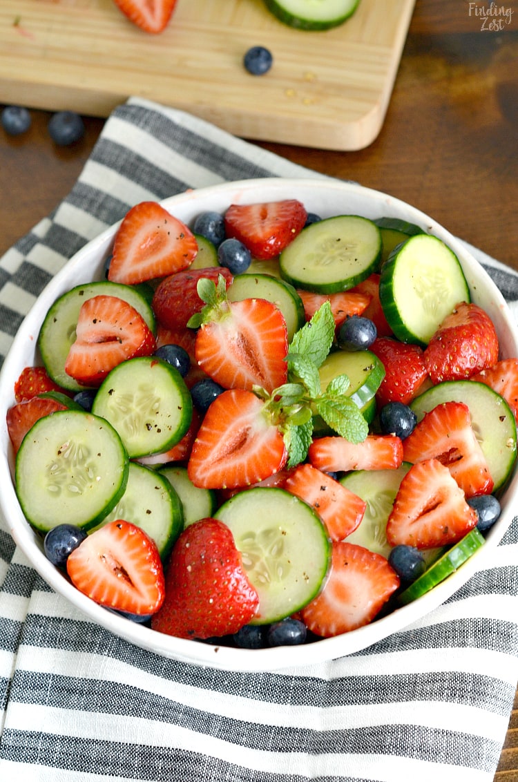 This Strawberry Cucumber Salad is your answer for what to serve with dinner tonight or at your next cookout. Loaded with fresh strawberries, cucumbers and blueberries, this refreshing summer side salad is so easy yet full of flavor!