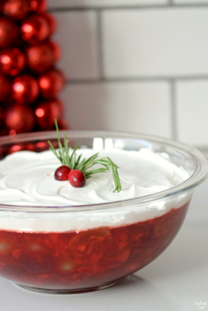 Cranberry Jello Salad is a new staple for your holiday feast! Whether you serve this cranberry salad for Thanksgiving or Christmas dinner, it is sure to be hit with Jello lovers! Featuring canned whole cranberries, crushed pineapples and sliced grapes, this is a colorful and refreshing holiday side dish!