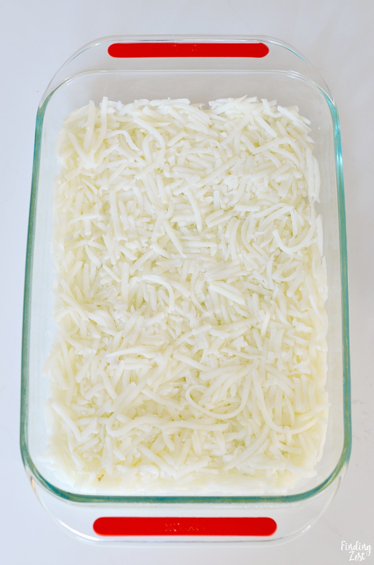 Layering fresh hash browns in baking dish