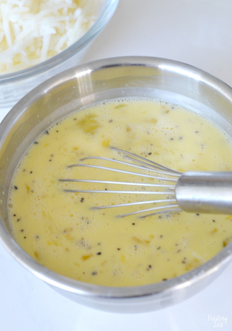 Whisking eggs in a bowl for hash brown bake