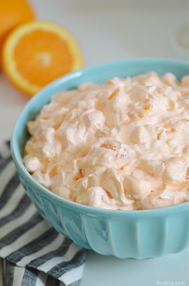 This Orange Fluff Salad is a quick side dish or dessert option featuring canned fruit, Jello and whipped topping. If you are looking for an orange fluff salad without cottage cheese, this recipe is for you!