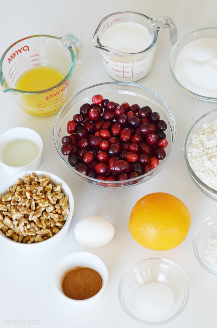 Ingredients for Cranberry Walnut Bread including fresh cranberries, orange , chopped walnuts, orange juice and milk