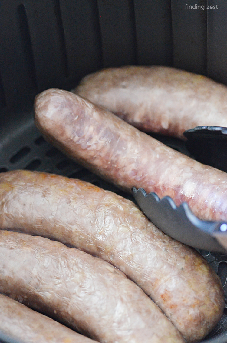 Turning Brats over halfway through cooking in an air fryer