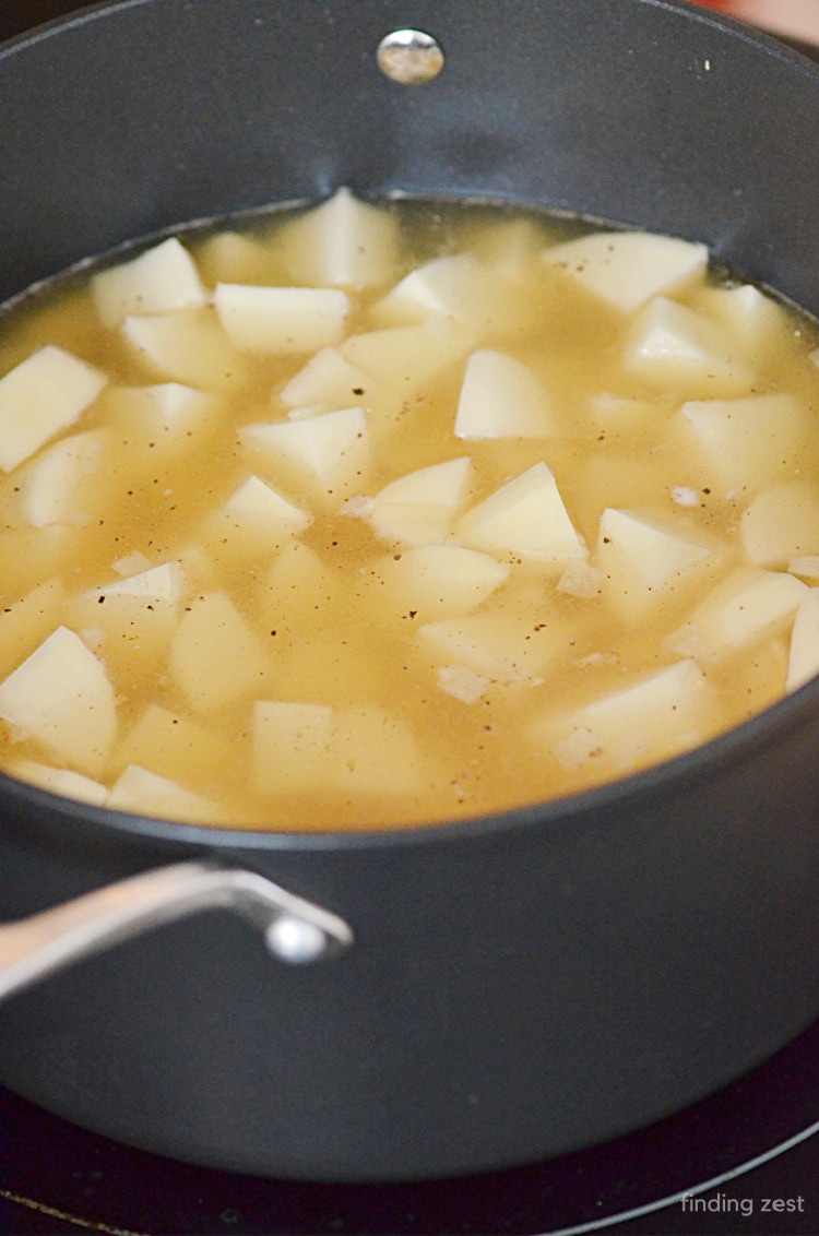 Cubed Potatoes cooking in broth for a creamy potato soup recipe