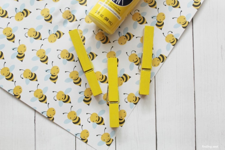 Paining wooden clothespin yellow for a bumble bee