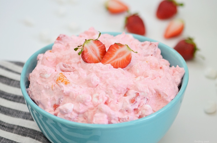 Strawberry fluff recipe with Jello, crushed pineapple, fresh strawberries, mandarin oranges, mini marshmallows and cool whip!