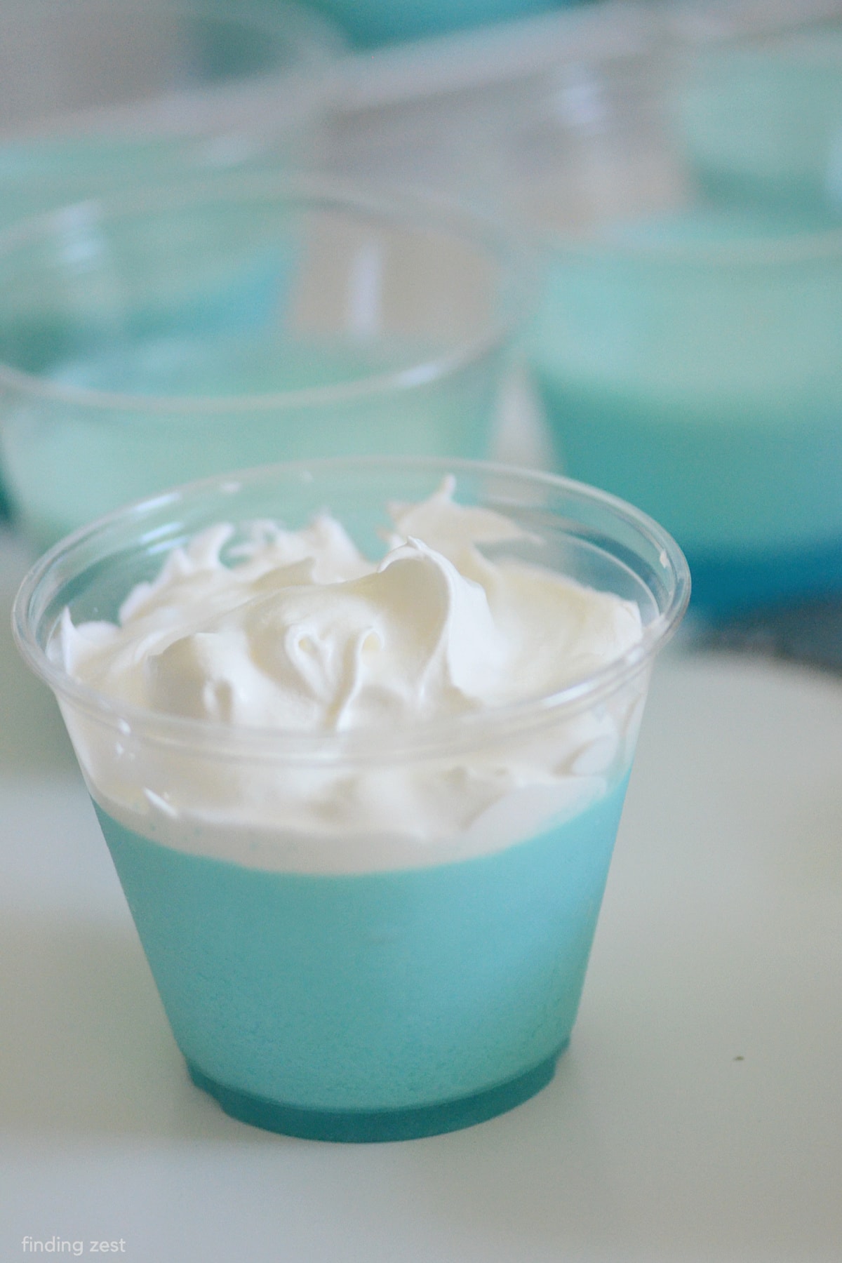 Blue jello cups with whipped topping