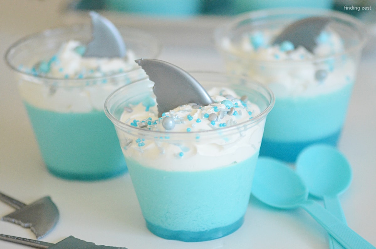 Looking for shark party ideas? Whether you are hosting a traditional shark themed party, baby shark party or celebrating Shark week, these jello cups are a perfect addition. Simple to make but so fun to eat, you need to try this shark jello!