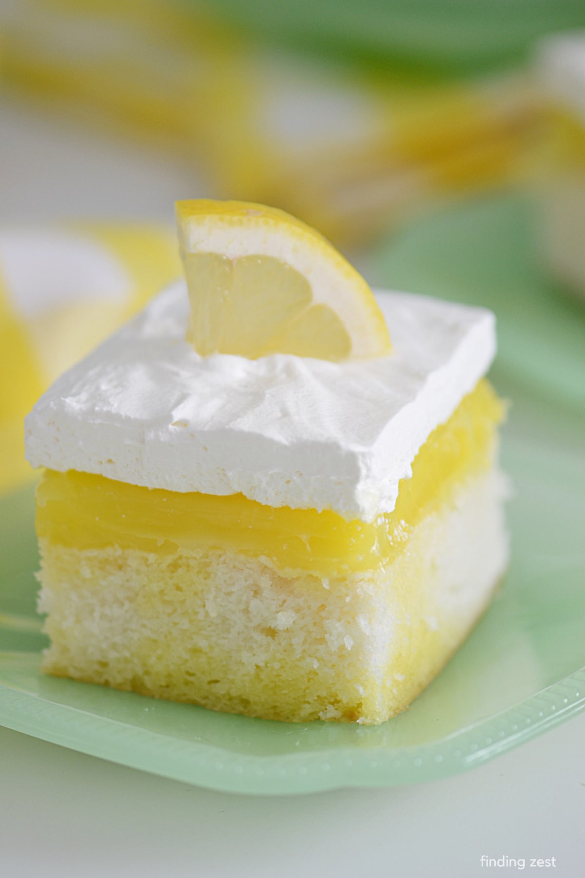 This lemon poke cake is incredibly easy to make and tastes amazing. The white cake mix and pie filling are combined with lemon jello for a delicious lemon flavor. Top with cool whip for the perfect finishing touch.