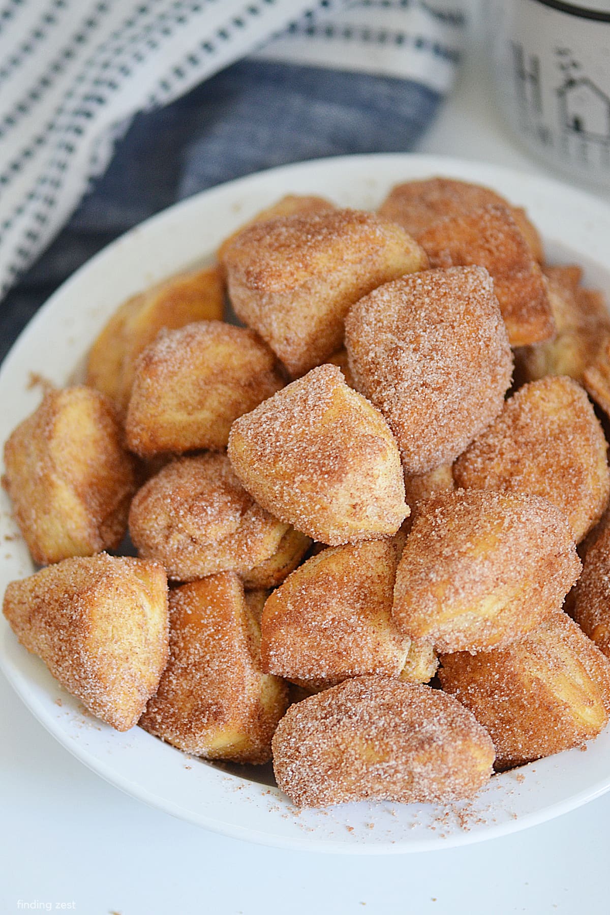 Air Fryer Donut Holes are so easy to make and taste delicious. You can use canned biscuits for a quick and easy donut that tastes great every day or on special occasions. Dust them with cinnamon and sugar for a sweet treat everyone will love.