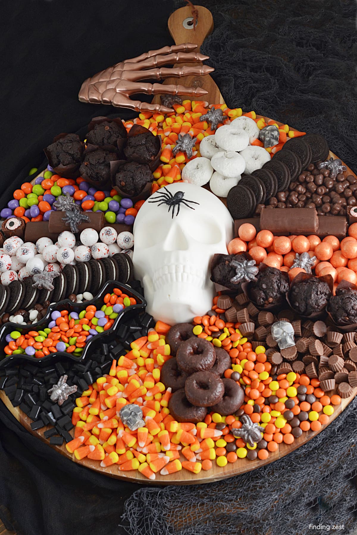 This Halloween Charcuterie Board is easy party treat and a great addition to your next Halloween bash! A chocolate skull, candy and dessert board that's sure to sweeten up the night. Easy step-by-step instructions are included to make the large 2D chocolate skull!