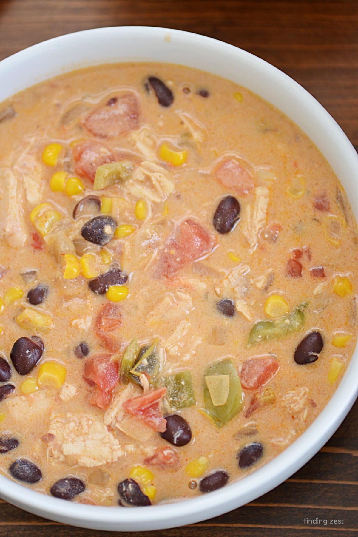 Creamy chicken enchiladas soup is an easy weeknight dinner option! Featuring leftover rotisserie chicken, this is a no-fuss meal that will fill you up on a cold winter day. This one-pot meal is a great recipe for busy families!