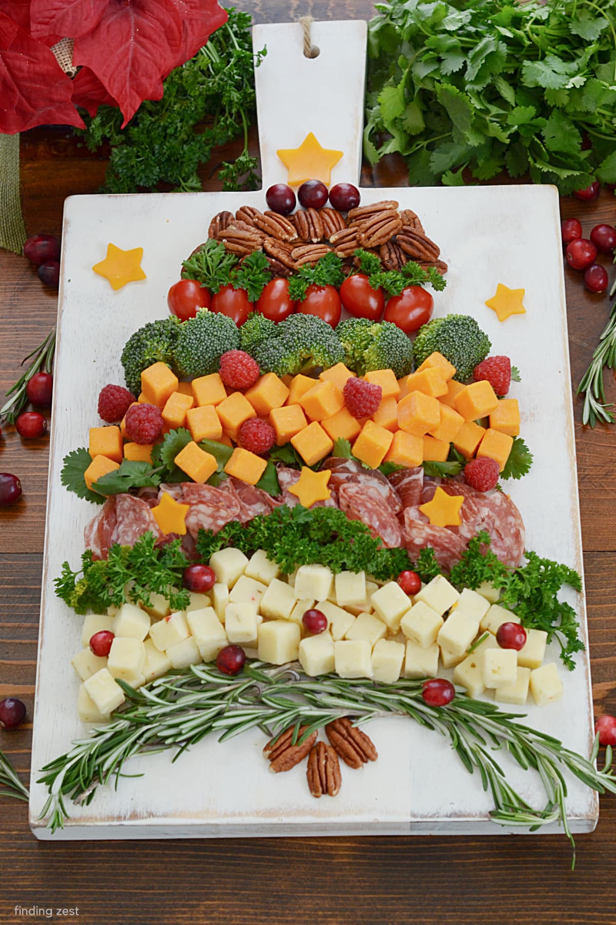 Searching for the perfect Christmas appetizer? This Christmas Tree Charcuterie Board is so easy to put together and easy for guests to nibble on as they mingle. Featuring cheese, meat, veggies fruit and nuts, everyone will love this festive snack board!
