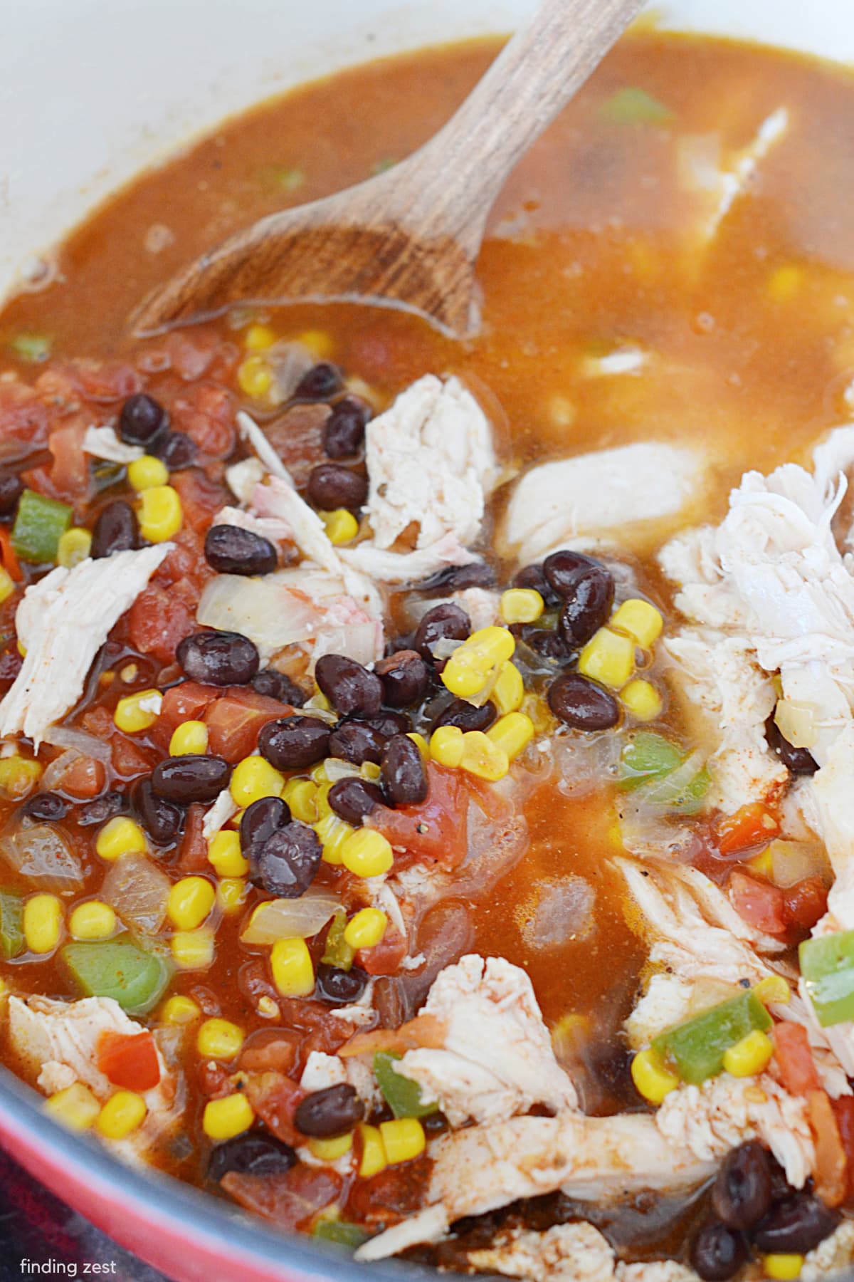 Chicken Enchilada Soup using leftover rotisserie chicken, is a hearty comfort food, perfect for warming up on a cold day. Top with your favorite enchilada toppings such as shredded cheese, sour cream and green onion for a great one-pot meal!