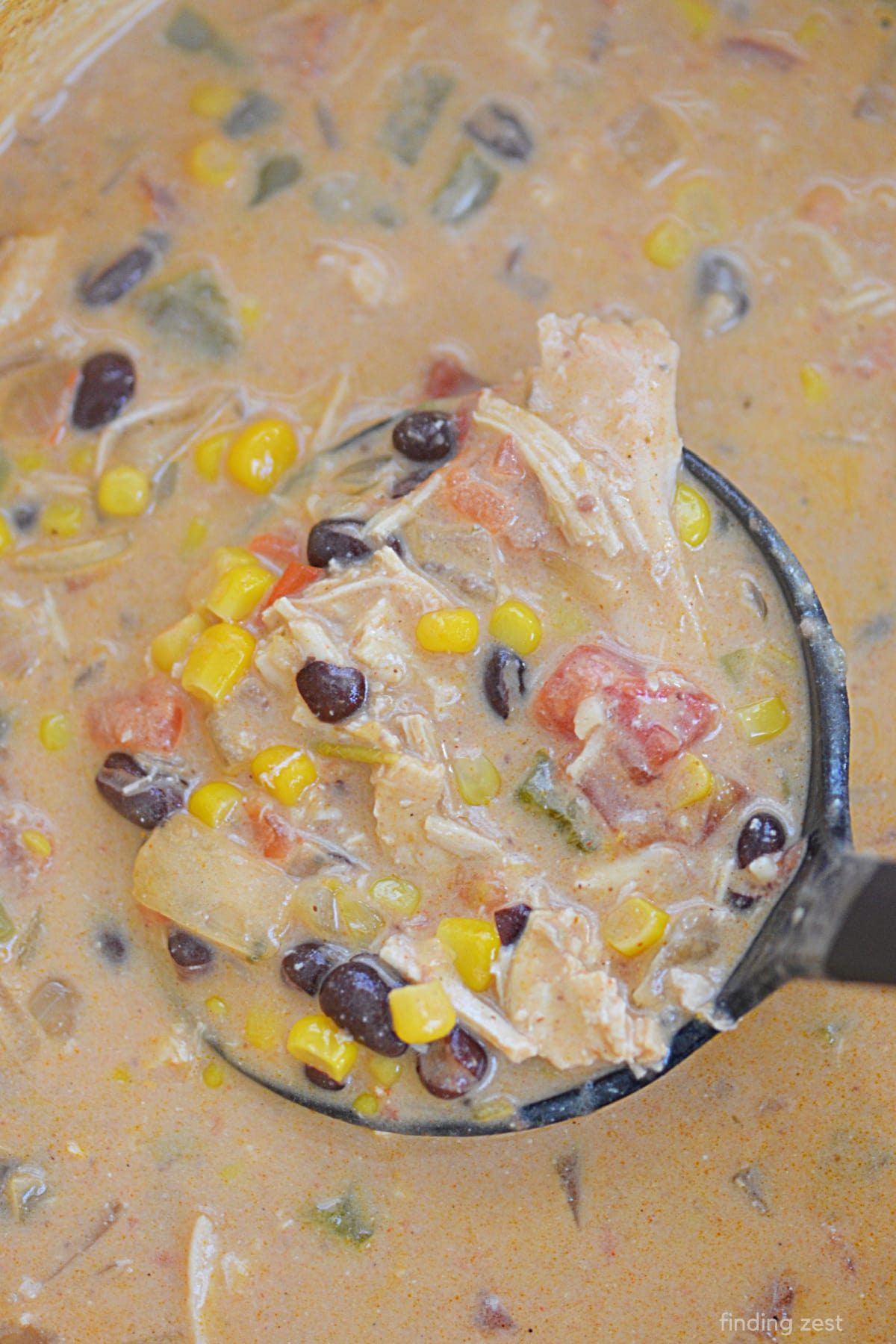 Creamy Chicen Enchilada Soup recipe featuring leftover shredded chicken, black beans, corn, enchilada sauce and cream cheese