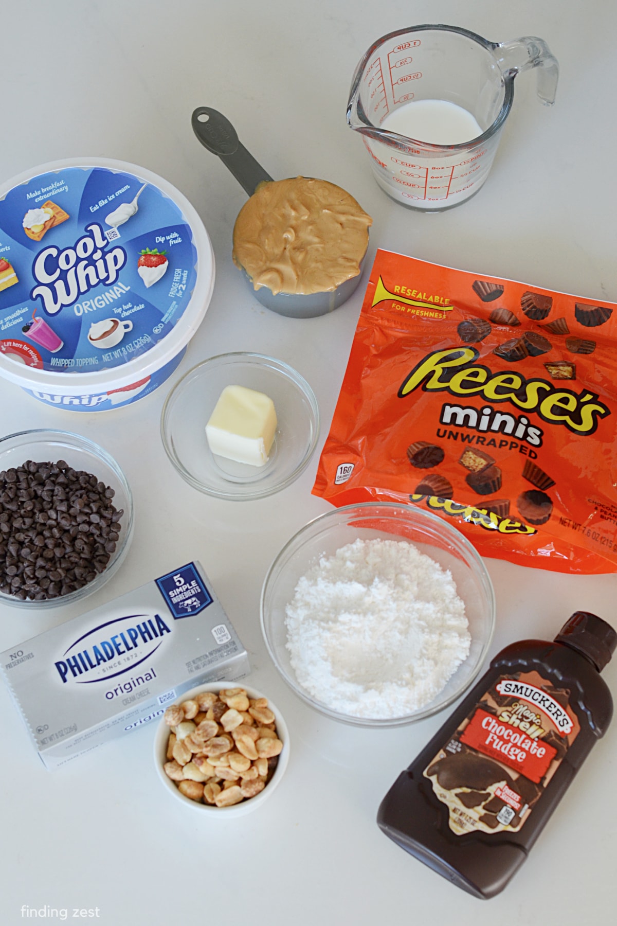 Ingredients to make peanut butter dip including cream cheese and cool whip