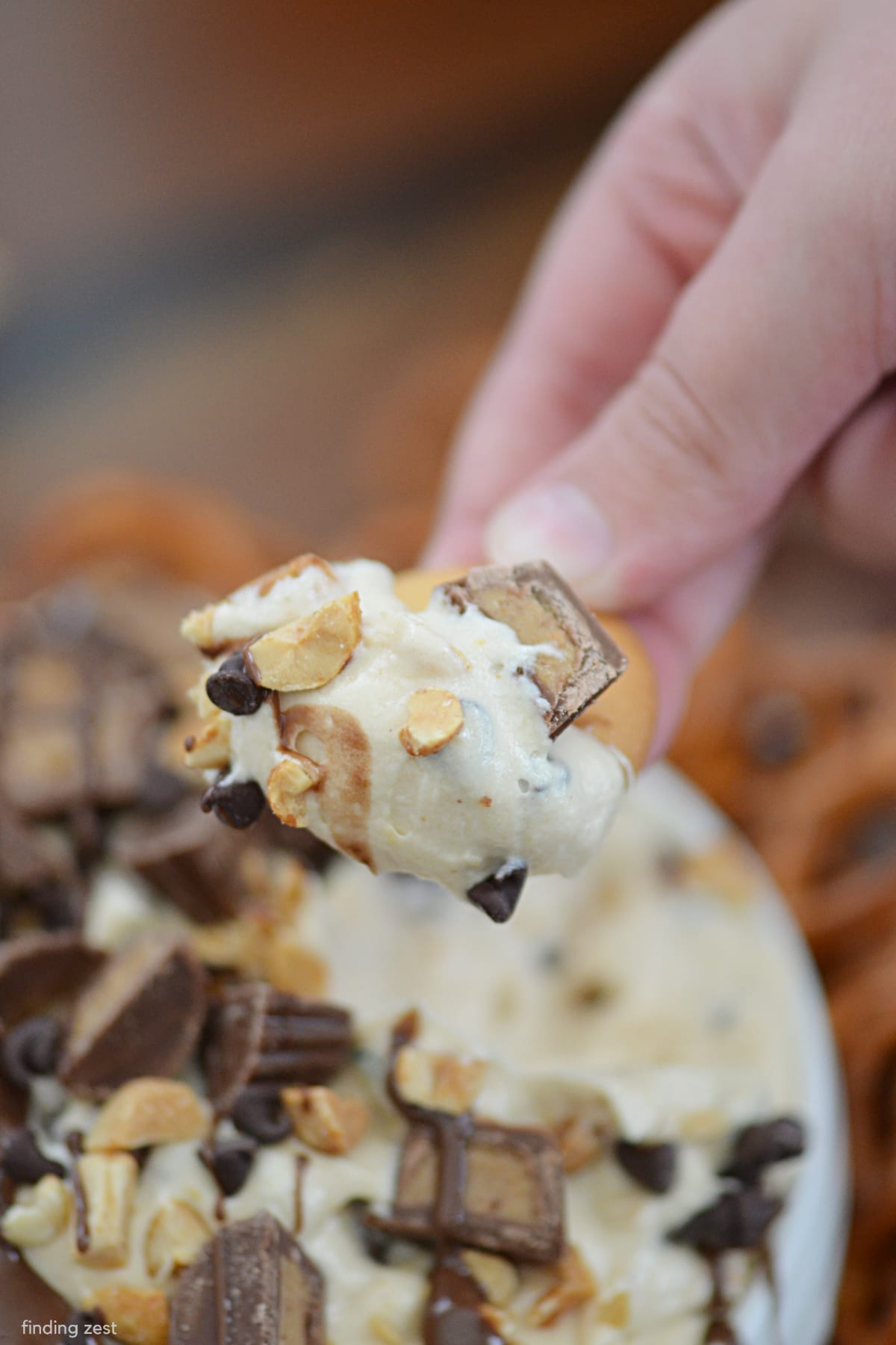 Peanut Butter Cup Dip is downright irresistable! This recipe for peanut butter dip is sure to be a hit at any party. Makes a great appetizer or no bake dessert option!