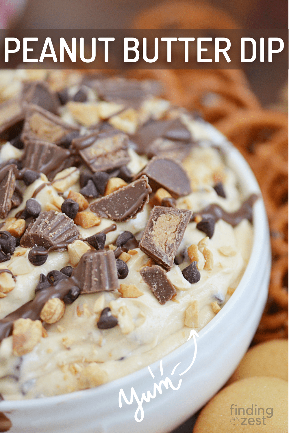 Peanut Butter Dip makes a the perfect party dessert dip! It's rich, creamy, and includes peanut butter, cream cheese, chopped peanuts, peanut butter cups and mini chocolate chips. Dip your favorite cookies, pretzels or vanilla wafers for the ultimate party appetizer or dessert!