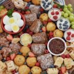 This epic Breakfast Charcuterie Board is loaded with easy brunch ideas that offer protein but can be served cold! Skip the hot foods and make an easy brunch board that guests will love with eggs, yogurt parfaits, fresh fruit and pastries. Also includes easy instructions for making honey butter!