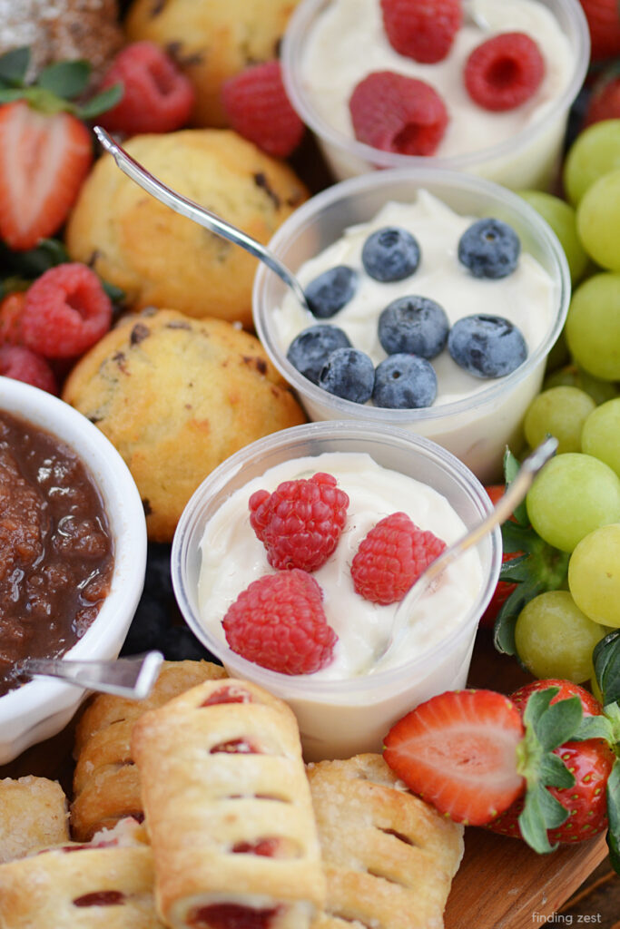 Yogurt parfaits on a charcuterie board for breakfast or brunch.