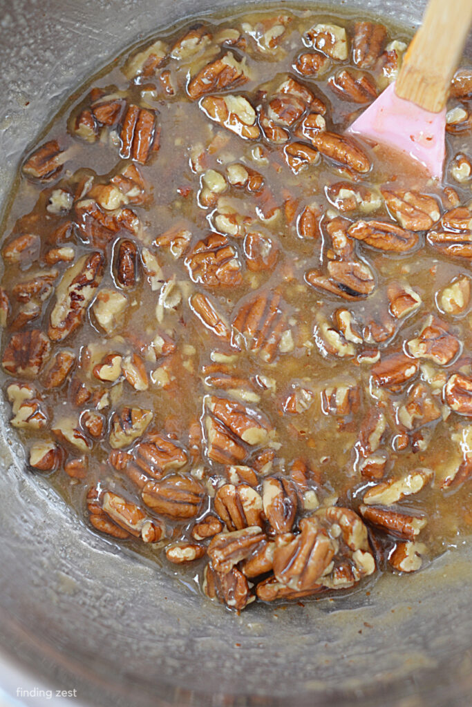 Pecan topping for a cake with pecans, brown sugar, melted butter and light corn syrup.
