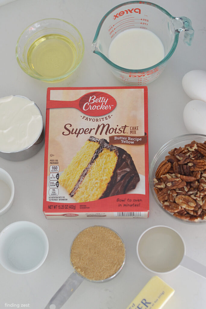Ingredients needed for a pecan upside down cake including yellow cake mix